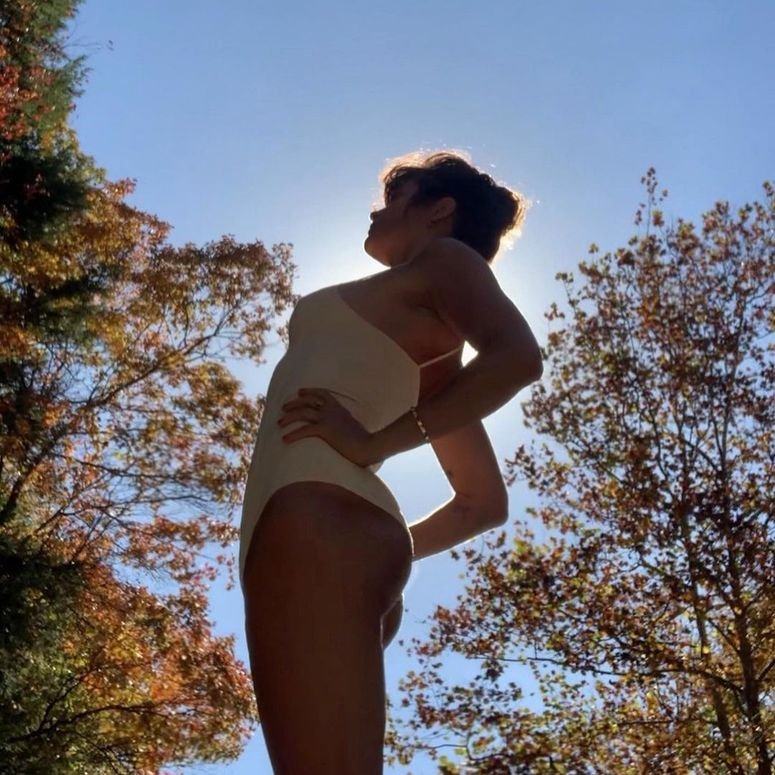 Image may contain: Human, Person, Clothing, Apparel, Plant, Tree, Back, Outdoors, Swimwear, Shorts, Nature, and Vegetation